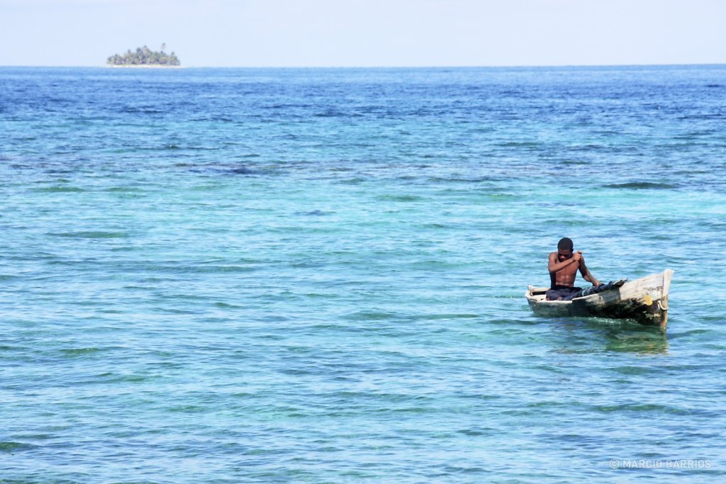 Garifuna boy with his canoe