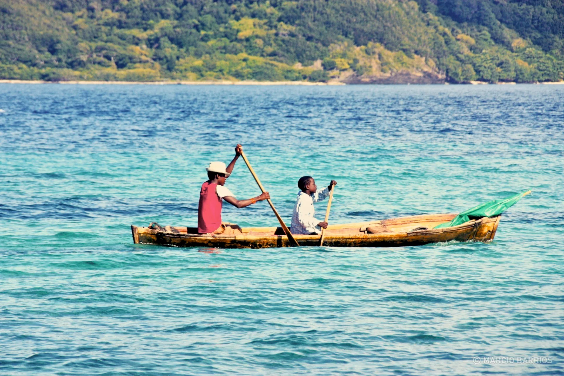A couple of garifuna boys with a canoe
